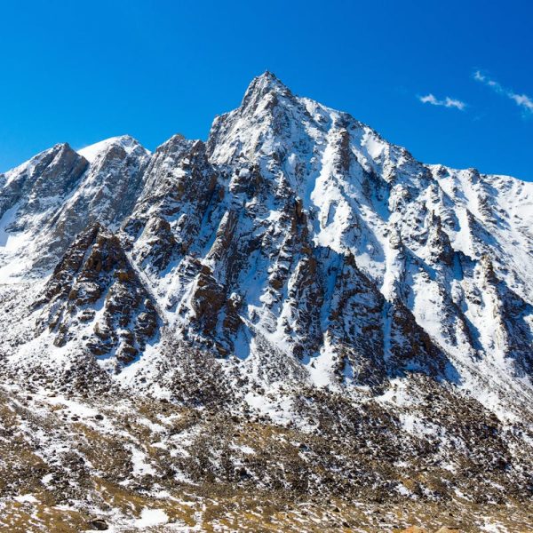 Snow-capped mountain peak in Western Sichuan under blue sky