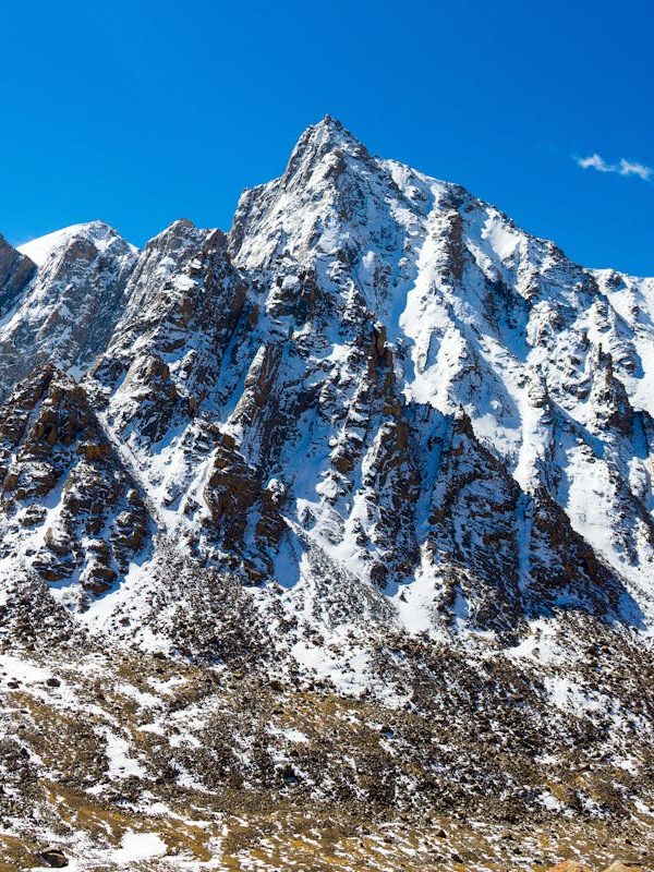 Snow-capped mountain peak in Western Sichuan under blue sky