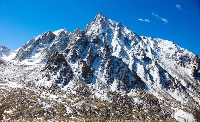 Snow-capped mountain peak in Western Sichuan under blue sky