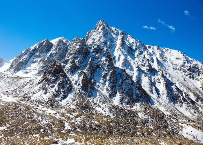Snow-capped mountain peak in Western Sichuan under blue sky